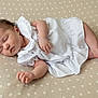 Esmée a rejoint le concours — aidez-le/la à gagner de superbes lots ! baby, sleeping, white_clothing, infant, cute, peaceful, laying_down, floral_pattern, blanket, soft, newborn, child, human, skin, arm, hand, foot, portrait, indoors, rest