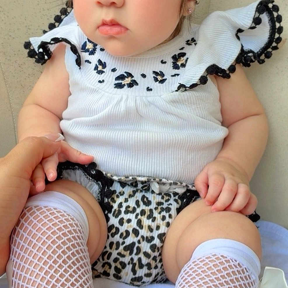 Ashley joined the competition — help win amazing prizes! adorable, baby, child, closeup, clothing, cute, fashion, feet, fishnet_stockings, hand, headband, indoors, legs, leopard_print, person, portrait, sitting, stylish, white_top, young_child