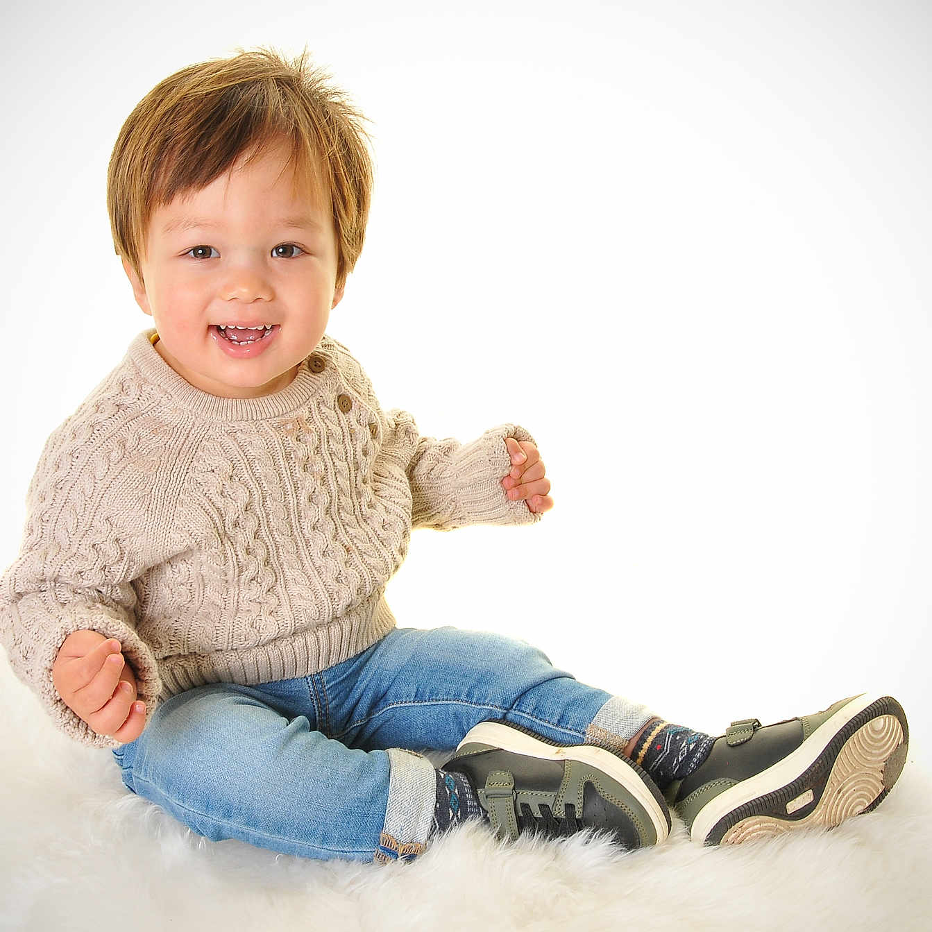 Jin is registered to the contest to win money with this photo: baby, bodypart, clothing, face, finger, footwear, hand, happy, head, jeans, knitwear, pants, person, photography, portrait, shoe, sitting, smile, sneaker, sweater