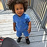Kash is registered to the contest to win money with this photo: child, toddler, afro_hair, blue_outfit, shorts, polo_shirt, outdoor, deck, wooden_floor, smiling, happy, standing, sunlight, shoes, black_shoes, colorful, patterned_clothing, daylight, person, cute