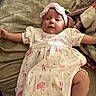 baby, infant, child, dress, headband, blanket, pink, white, pattern, soft, cute, lying_down, arms_outstretched, legs_outstretched, indoor, comfort, expression, face, person, toddler