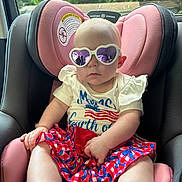 Lainey joined the competition — help win amazing prizes! baby, child, car_seat, sunglasses, heart_shaped, purple, pink, clothing, summer, outdoor, window, reflection, person, infant, cute, seat, skirt, shirt, patterned, casual