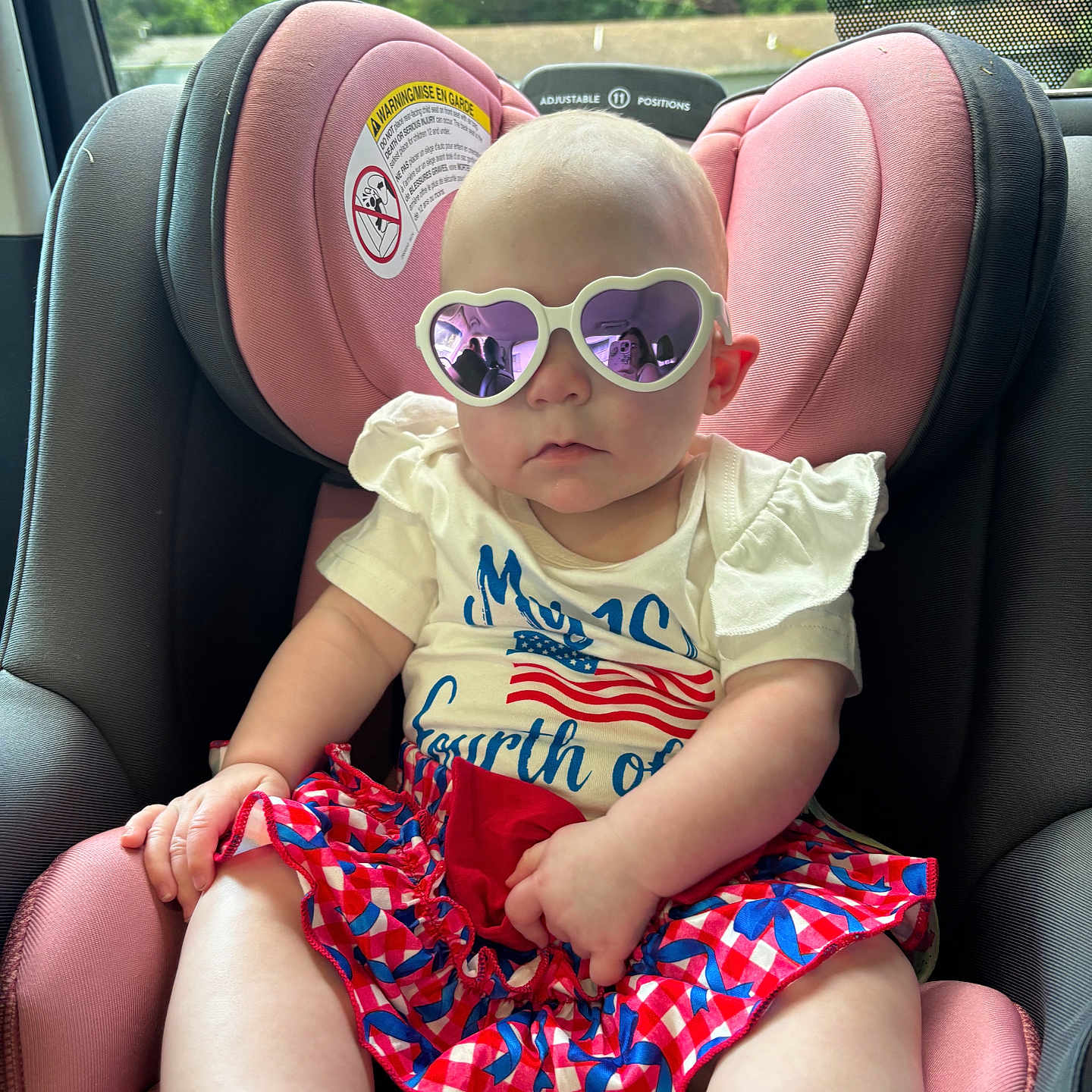 Lainey joined the competition — help win amazing prizes! baby, child, car_seat, sunglasses, heart_shaped, purple, pink, clothing, summer, outdoor, window, reflection, person, infant, cute, seat, skirt, shirt, patterned, casual
