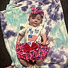 baby, infant, blanket, headband, bow, red, white, blue, clothing, foot, toenails, carpet, person, lying_down, pattern, cute, soft_texture, patriotic, shoes, toddler