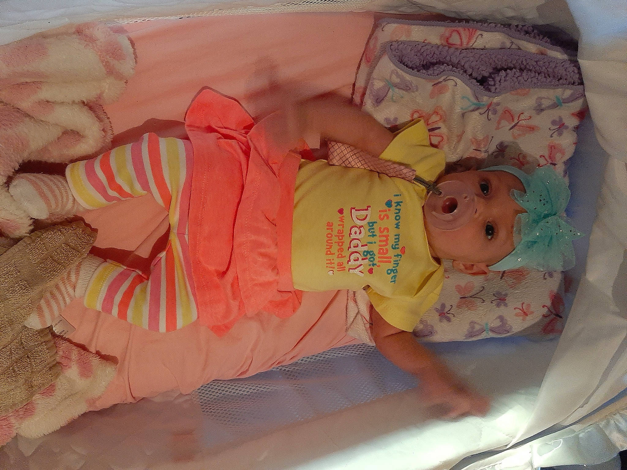 Naomi is registered to the contest to win money with this photo: arm, baby, baby_products, baby_safety, baby_toddler_clothing, baby_toys, child, comfort, hand, headwear, linens, pattern, peach, person, pink, room, skin, textile, toddler, windshield