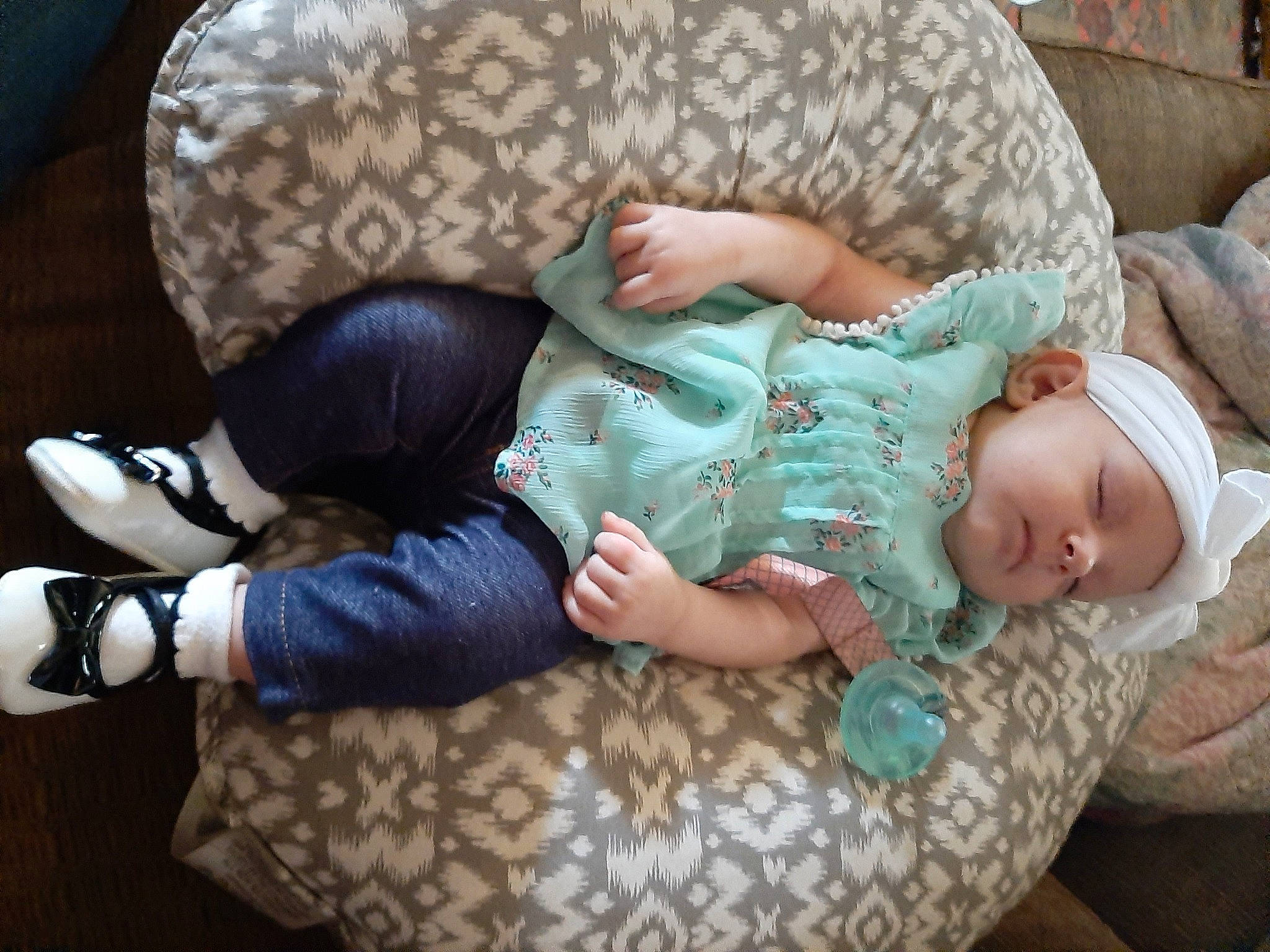 Naomi is registered to the contest to win money with this photo: baby, baby_products, baby_sleeping, baby_toddler_clothing, cheek, child, comfort, foot, headwear, human_body, human_leg, lap, leg, linens, person, sitting, skin, sleeve, sock, thigh