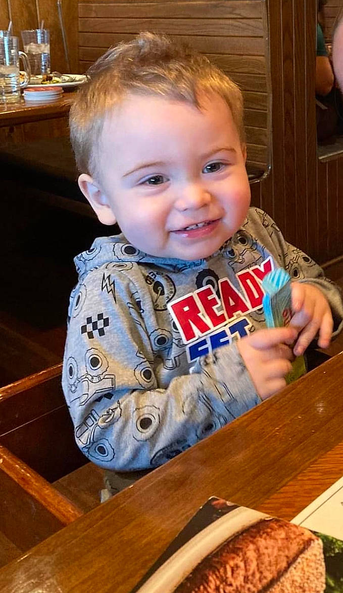 Kaleb is registered to the contest to win money with this photo: baby, baby_toddler_clothing, chair, child, flooring, food, gluten, hair, happy, ingredient, joy, junk_food, person, plate, recipe, sitting, smile, t_shirt, table, tableware