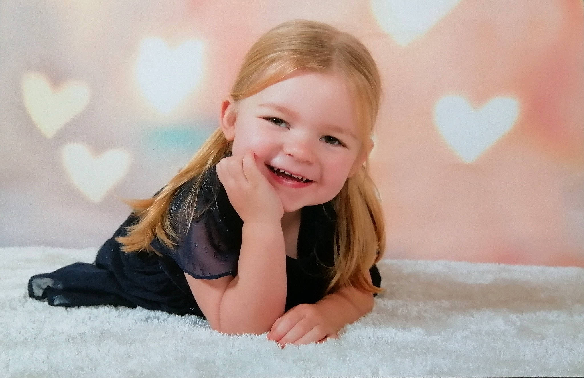 Jessie is registered to the contest to win money with this photo: brown_hair, cheek, child, dress, face, finger, flash_photography, floor, flooring, fun, gesture, happy, human_leg, joy, leisure, long_hair, person, room, skin, smile