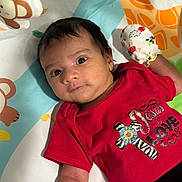 John joined the competition — help win amazing prizes! baby, infant, face, red_shirt, mitten, playmat, monkey_pattern, colorful, cute, child, apparel, handwear, lying_down, portrait, young, skin, hair, expression, indoors, resting