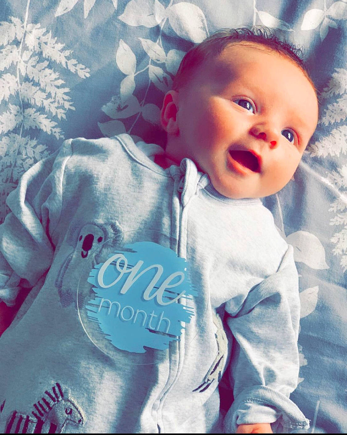 Jenson is registered to the contest to win money with this photo: baby, baby_products, baby_sleeping, baby_toddler_clothing, child, cloud, cool, electric_blue, font, happy, linens, pattern, people_in_nature, person, pink, portrait_photography, sky, sleeve, t_shirt, textile