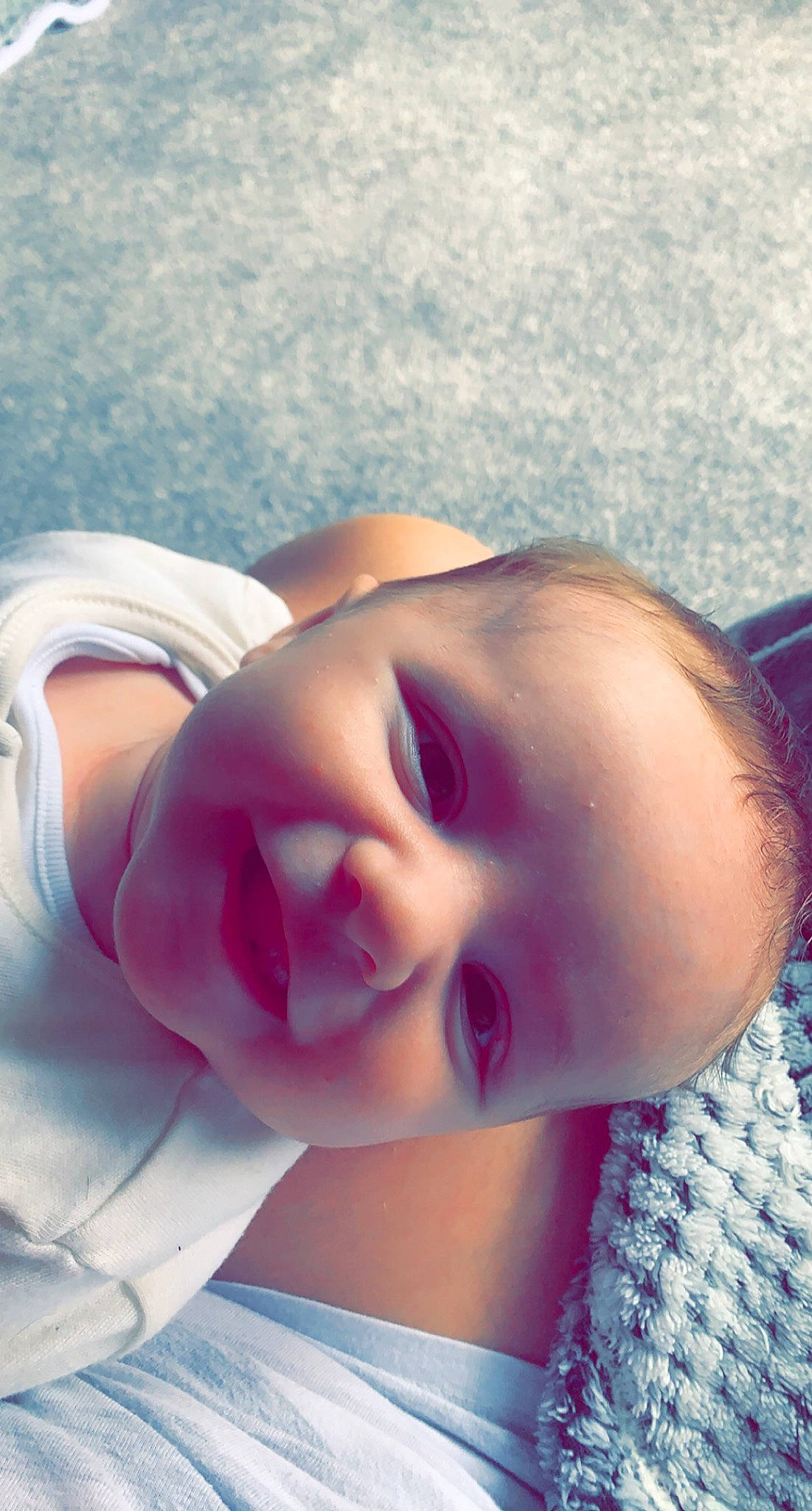 Jenson is registered to the contest to win money with this photo: baby, baby_toddler_clothing, cheek, child, comfort, cool, eyebrow, eyelash, grass, happy, lip, mouth, neck, nose, person, pink, purple, skin, sky, smile