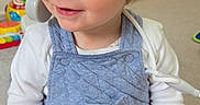 Oakley is registered to the contest to win money with this photo: baby, blond_hair, blue_eyes, carpet, child, cute, hands, happy, indoor, onesie, overalls, playroom, playtime, portrait, sitting, smile, stethoscope, toddler, toy, toy_phone
