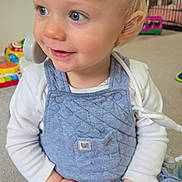 Oakley joined the competition — help win amazing prizes! baby, blond_hair, blue_eyes, carpet, child, cute, hands, happy, indoor, onesie, overalls, playroom, playtime, portrait, sitting, smile, stethoscope, toddler, toy, toy_phone