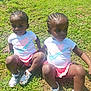 child, toddler, grass, outdoor, sunlight, braided_hair, white_shirt, pink_skirt, sandals, nike_logo, sitting, holding_hands, daylight, nature, greenery, casual_clothing, cute, pair, two_children, summer