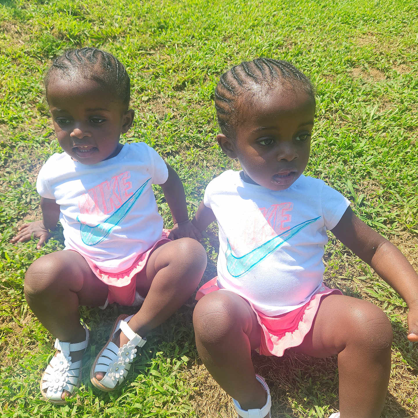 Lark And Lotus joined the competition — help win amazing prizes! braided_hair, casual_clothing, child, cute, daylight, grass, greenery, holding_hands, nature, nike_logo, outdoor, pair, pink_skirt, sandals, sitting, summer, sunlight, toddler, two_children, white_shirt