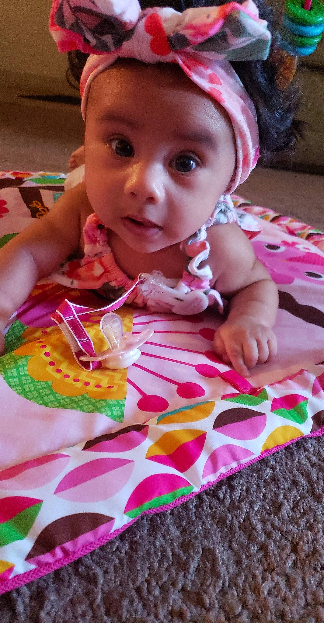 Odessa is registered to the contest to win money with this photo: baby, baby_toddler_clothing, cheek, child, headwear, linens, person, pink, play, surprise, textile, toddler