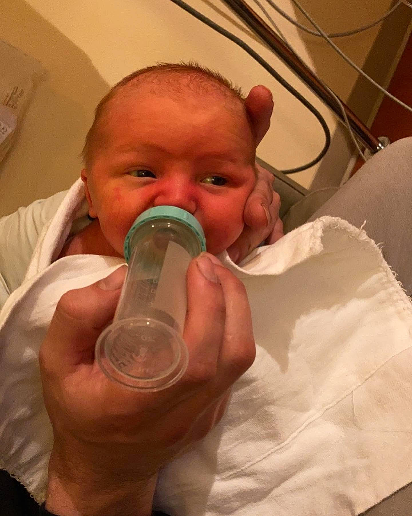 Linkin is registered to the contest to win money with this photo: baby, bottle, cheek, chin, drinkware, ear, eyebrow, eyelash, finger, fluid, gesture, hand, health_care, jaw, liquid, mouth, neck, nose, person, plastic_bottle