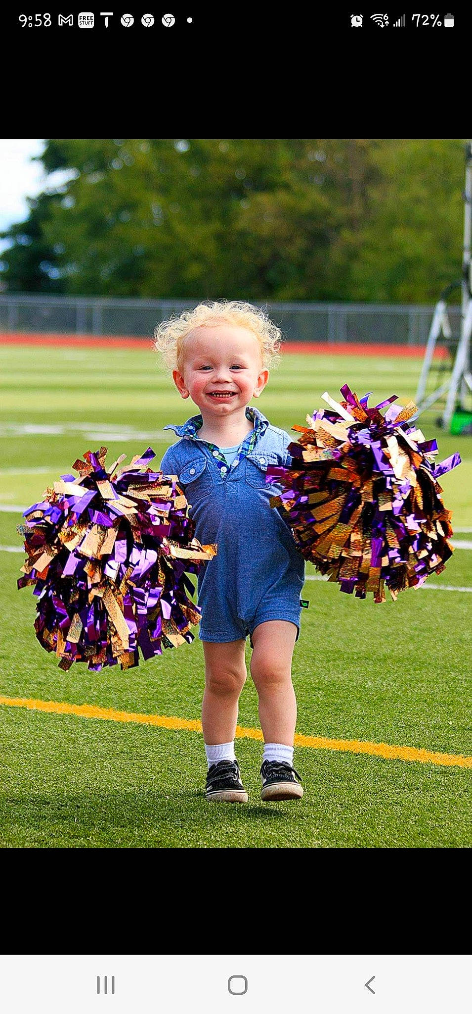 Kenneth is registered to the contest to win money with this photo: ball_game, championship, cheerleading_uniform, community, competition_event, fun, grass, joy, mammal, people, person, player, purple, shoe, smile, sneakers, sports, summer, team_sport, toddler