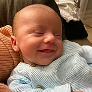 Tiago a rejoint le concours — aidez-le/la à gagner de superbes lots ! baby, smiling, sleeping, face, infant, knitwear, blue_sweater, cushion, cozy, comfort, peaceful, child, portrait, indoors, soft_lighting, cute, close_up, happy, resting, newborn