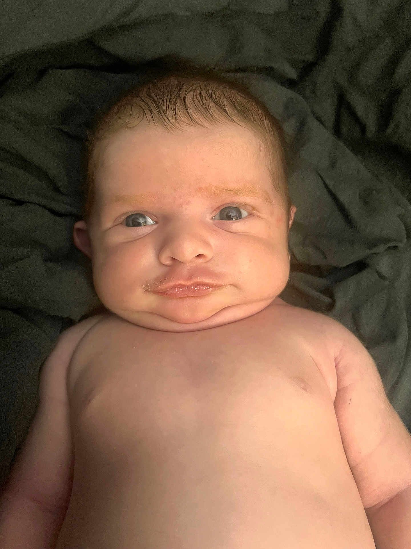 Jager joined the competition — help win amazing prizes! baby, infant, face, skin, expression, eyes, cheeks, mouth, hair, shoulders, torso, lying_down, blanket, cute, closeup, portrait, child, human, newborn, soft