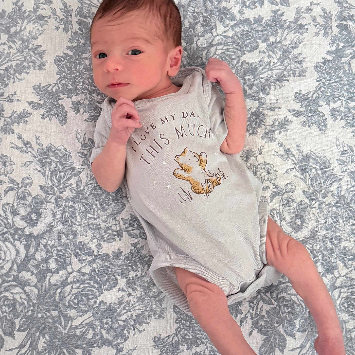 Theodoro joined the competition — help win amazing prizes! newborn, baby, infant, onesie, clothing, lying_down, blanket, floral_pattern, cute, face, hand, foot, skin, person, portrait, indoors, sleepy, small, infant_clothing, baby_garment