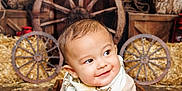 Nicholas joined the competition — help win amazing prizes! baby, child, smiling, wooden_box, barn, wagon_wheel, string_lights, hay, meat, plate, floor, scarf, cute, indoor, rustic, decor, wood, happy, infant, portrait