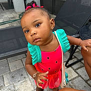 Nature joined the competition — help win amazing prizes! toddler, child, curious, outdoor, watermelon_outfit, pink, green, purse, bracelet, barefoot, patio, stone_floor, black_hair, curly_hair, earrings, summer, playful, person, fashion, cute
