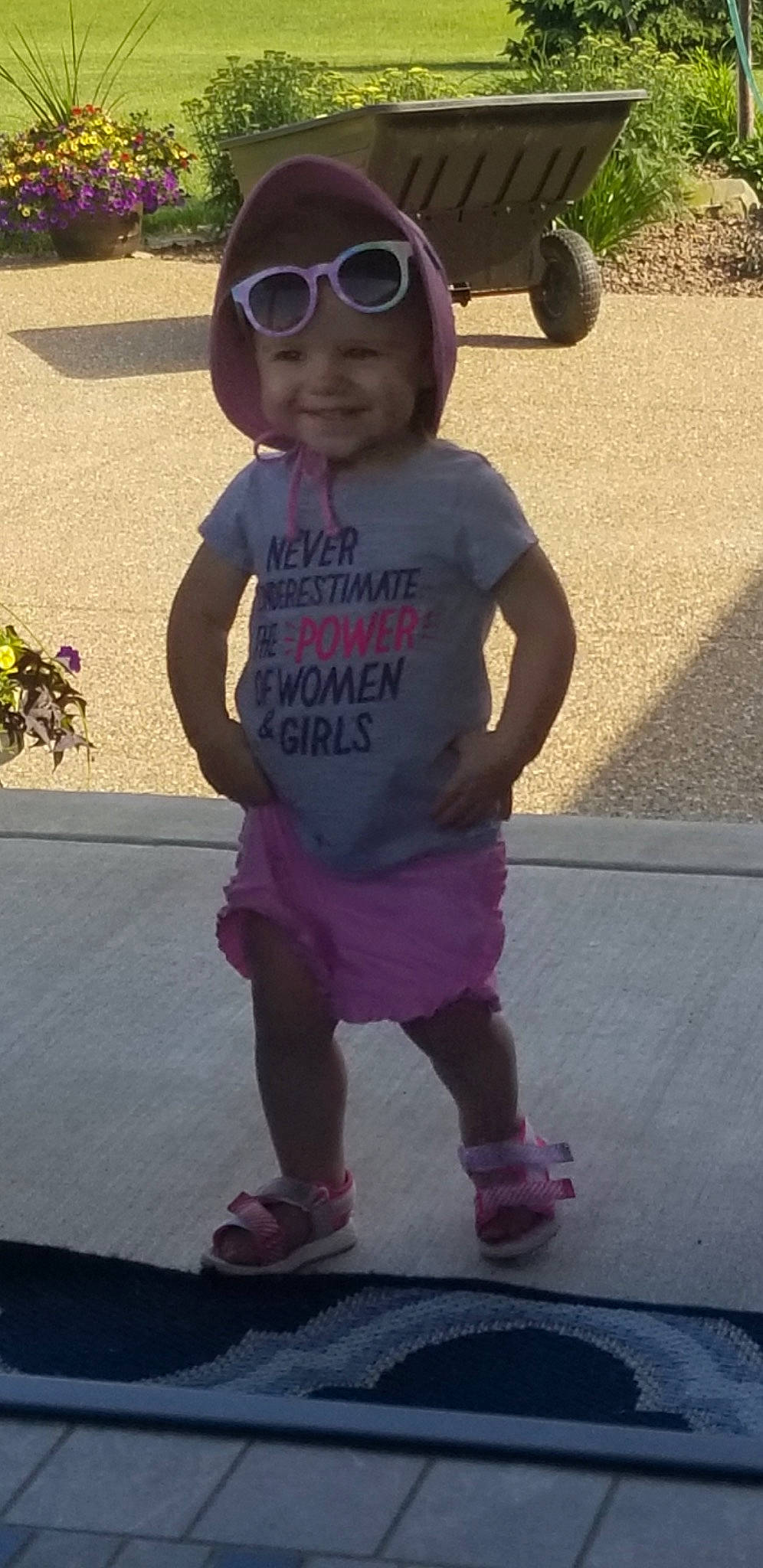 Avery is registered to the contest to win money with this photo: asphalt, baby_toddler_clothing, eyewear, footwear, fun, goggles, happy, hat, headwear, joy, leisure, person, pink, plant, purple, sleeve, smile, standing, sunglasses, t_shirt