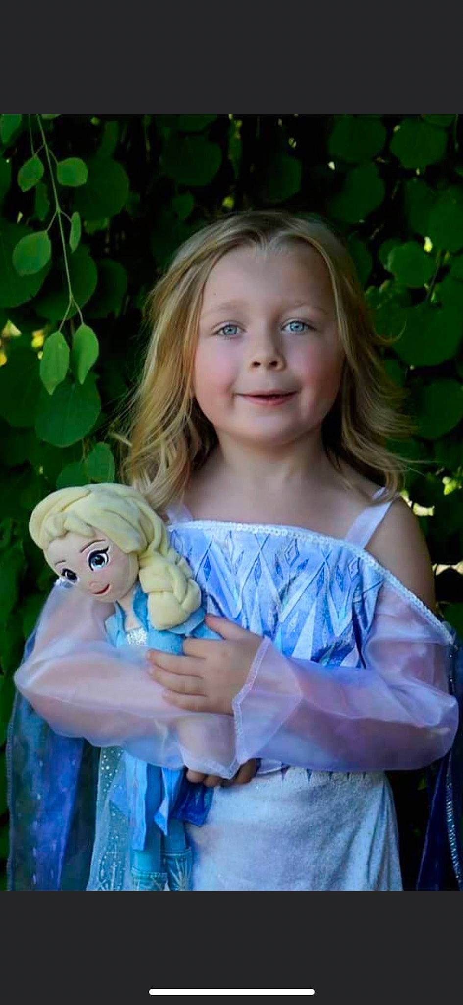 Talia is registered to the contest to win money with this photo: botany, child, doll, dress, facial_expression, fawn, gesture, grass, hairstyle, hand, happy, iris, joy, long_hair, people_in_nature, person, pink, plant, skin, smile