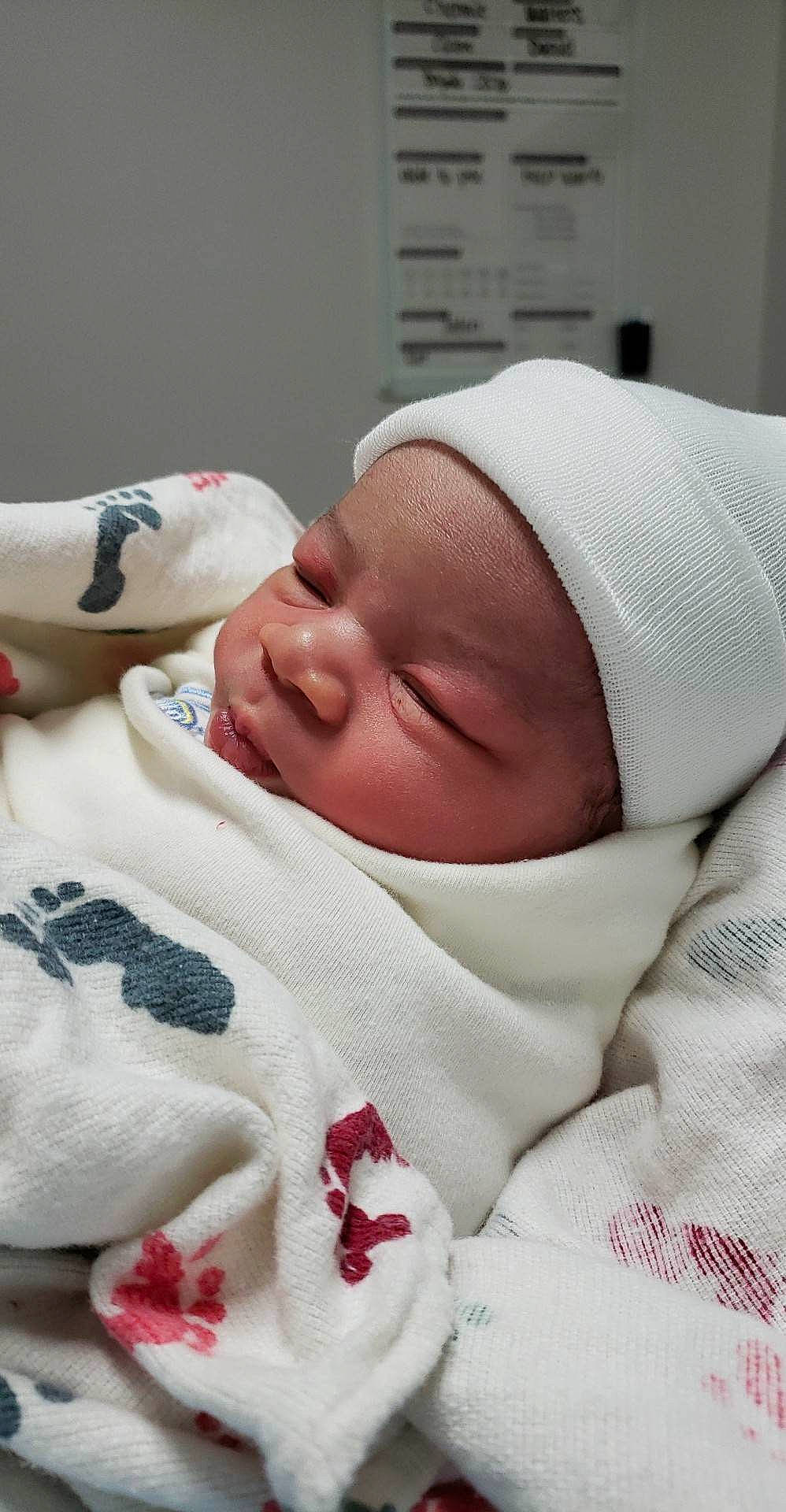 Jaden is registered to the contest to win money with this photo: baby, baby_sleeping, baby_toddler_clothing, bedtime, carmine, child, childbirth, comfort, event, hat, headwear, linens, person, skin, toddler