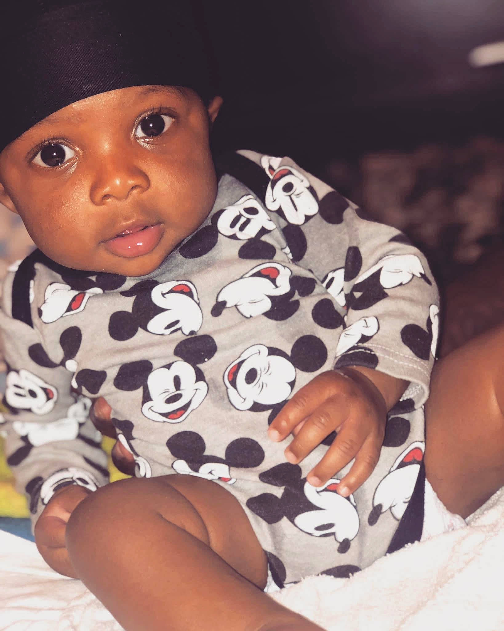 Zakai is registered to the contest to win money with this photo: arm, baby, baby_toddler_clothing, black, cap, cheek, child, comfort, cool, finger, flash_photography, happy, hat, headwear, lip, nose, person, skin, sleeve, thigh