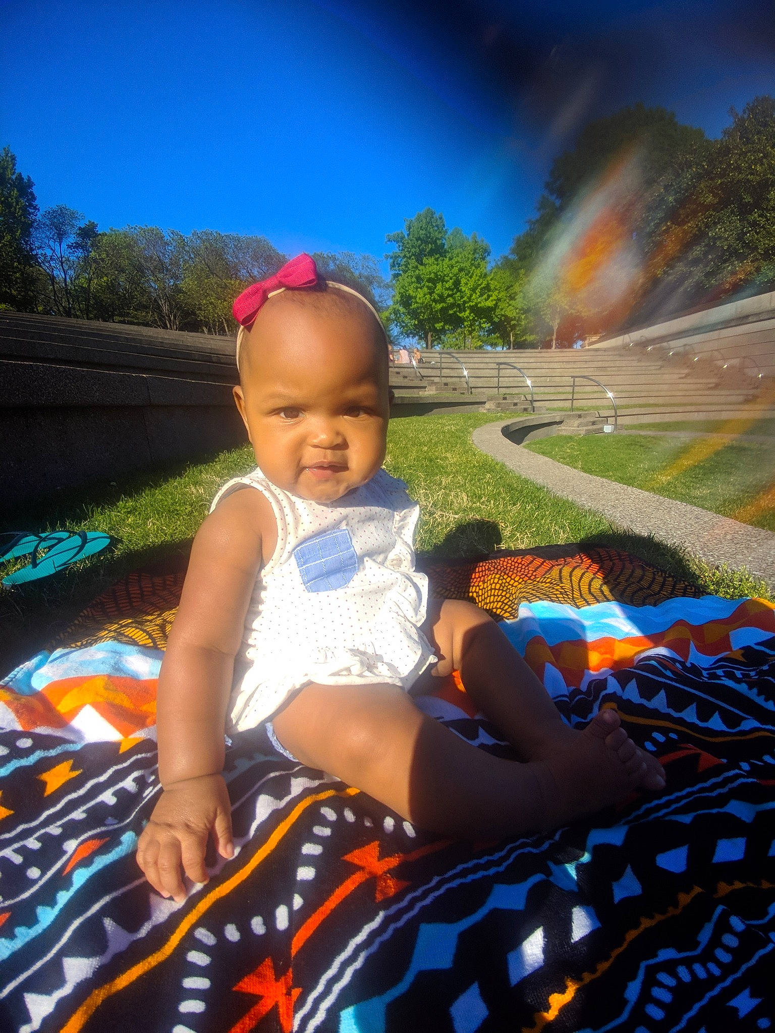 Zola is registered to the contest to win money with this photo: baby, child, cool, fun, grass, landscape, leisure, person, photography, plant, play, recreation, sitting, skin, sky, smile, summer, sunlight, toddler, tree