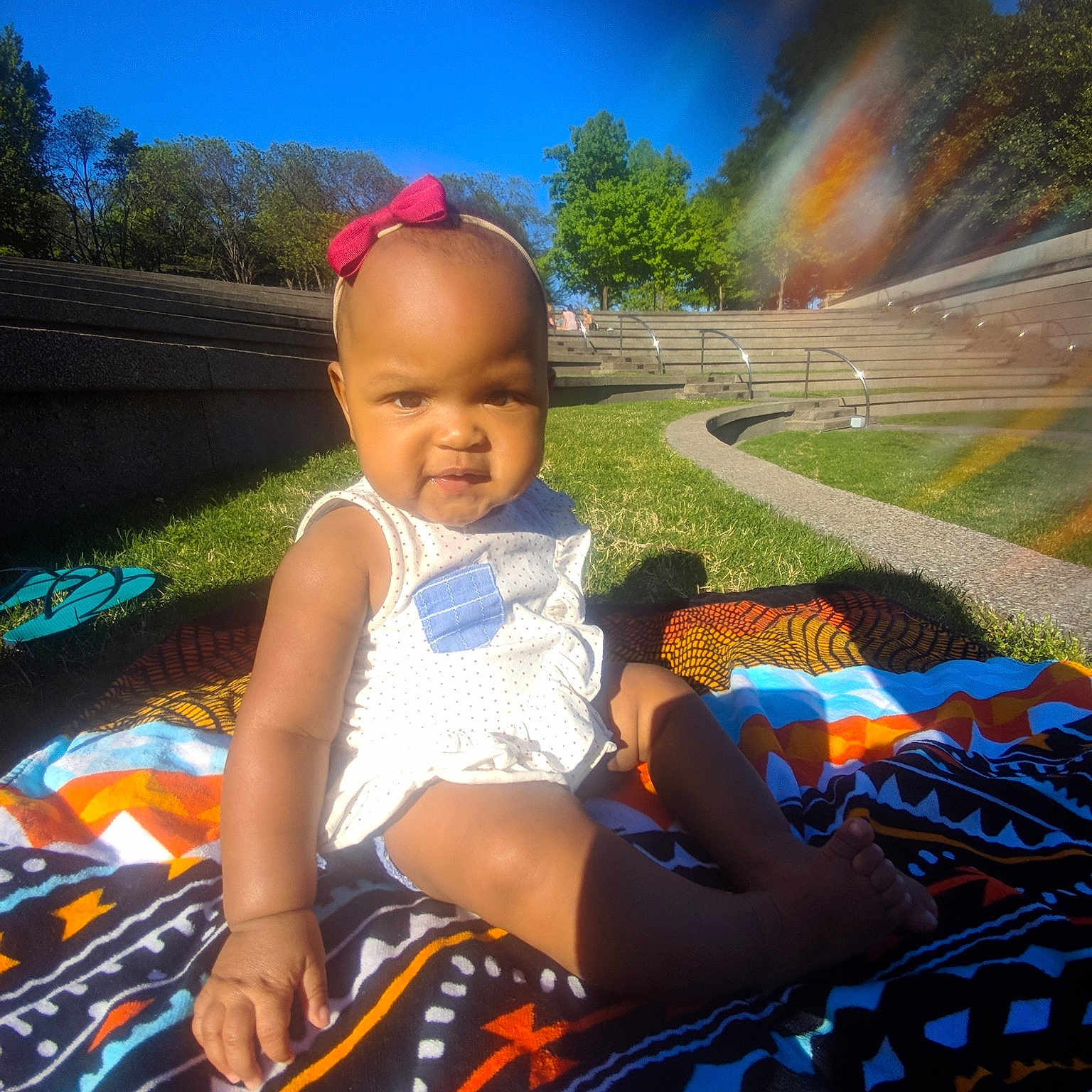 Zola is registered to the contest to win money with this photo: baby, child, cool, fun, grass, landscape, leisure, person, photography, plant, play, recreation, sitting, skin, sky, smile, summer, sunlight, toddler, tree