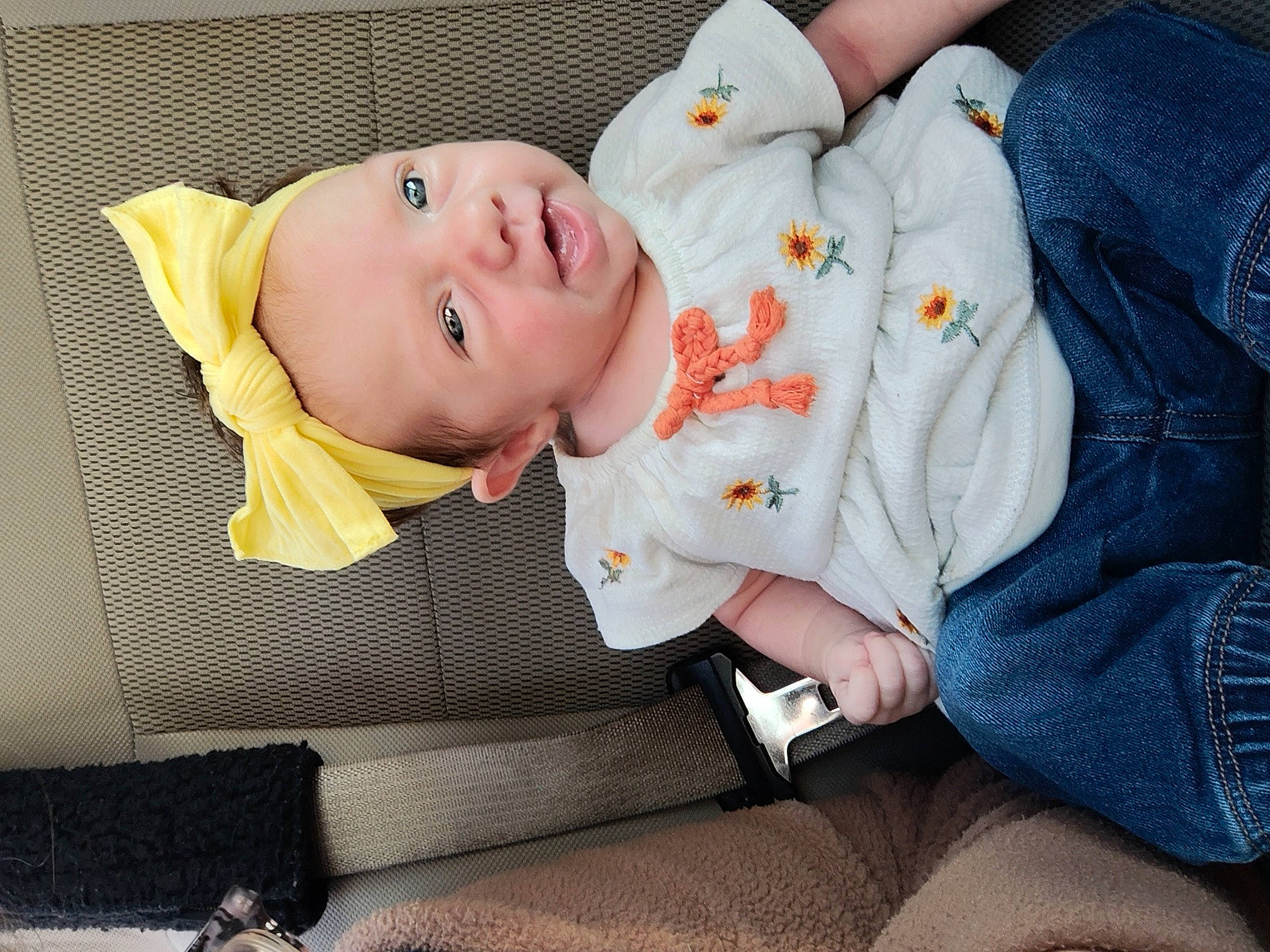 Arabella is registered to the contest to win money with this photo: baby, baby_products, baby_toddler_clothing, cheek, child, clothing, collar, comfort, denim, grass, happy, hat, orange, person, portrait_photography, sitting, sleeve, smile, toddler, tree
