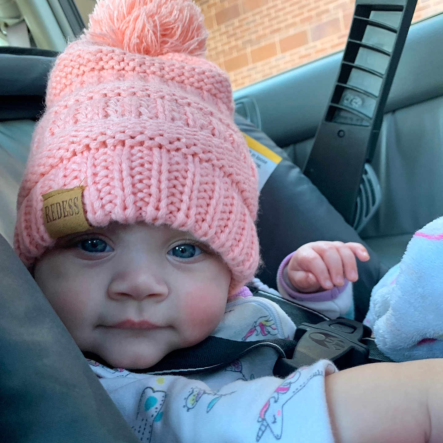 Kylie joined the competition — help win amazing prizes! baby, beanie, bodypart, bonnet, cap, car, car_interior, clothing, face, finger, glove, hand, hat, head, newborn, person, photography, portrait, transportation, vehicle
