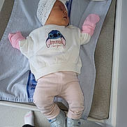 Gabrielle participe au concours pour gagner de l'argent avec cette photo : baby, sleeping, headwrap, pink_clothing, white_shirt, shoes, towel, blanket, infant, cute, indoor, person, footwear, soft_toys, sleep, child, apparel, resting, floor, baby_mittens