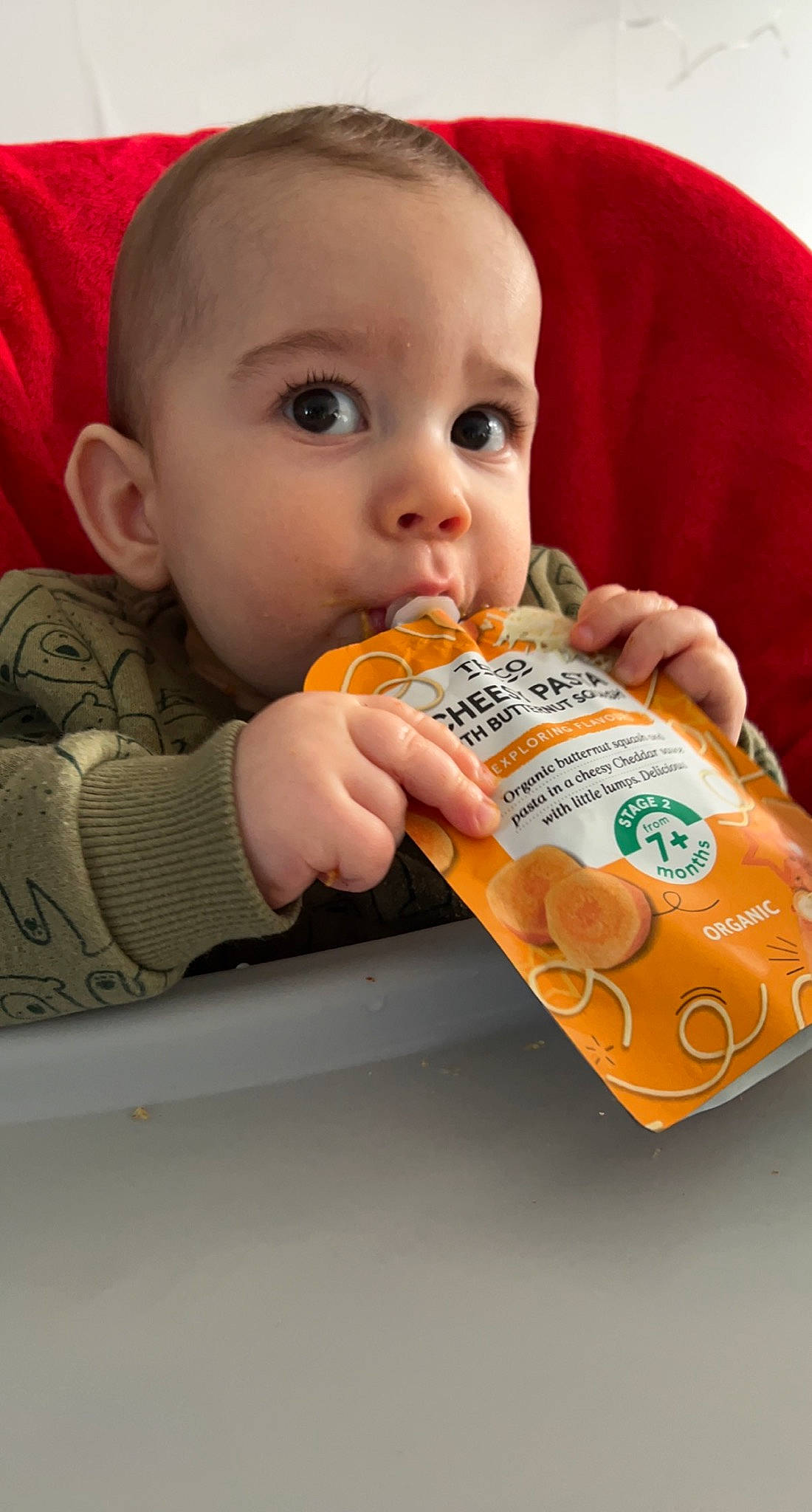 Issac is registered to the contest to win money with this photo: baby, baby_toddler_clothing, cheek, child, comfort_food, eye, face, finger, finger_food, food, food_craving, head, junk_food, nose, orange, person, product, skin, surprise, sweetness