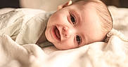 Finnley joined the competition — help win amazing prizes! baby, smiling, face, blanket, soft, infant, cute, portrait, lying_down, warm_lighting, happy, child, closeup, skin, expression, indoors, young, cozy, head, eyes