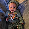 Finnley joined the competition — help win amazing prizes! baby, infant, child, smiling, face, blue_blanket, green_outfit, tigger, cartoon_character, lying_down, cozy, cute, indoors, soft_texture, headwear, happy, person, portrait, clothing, blanket