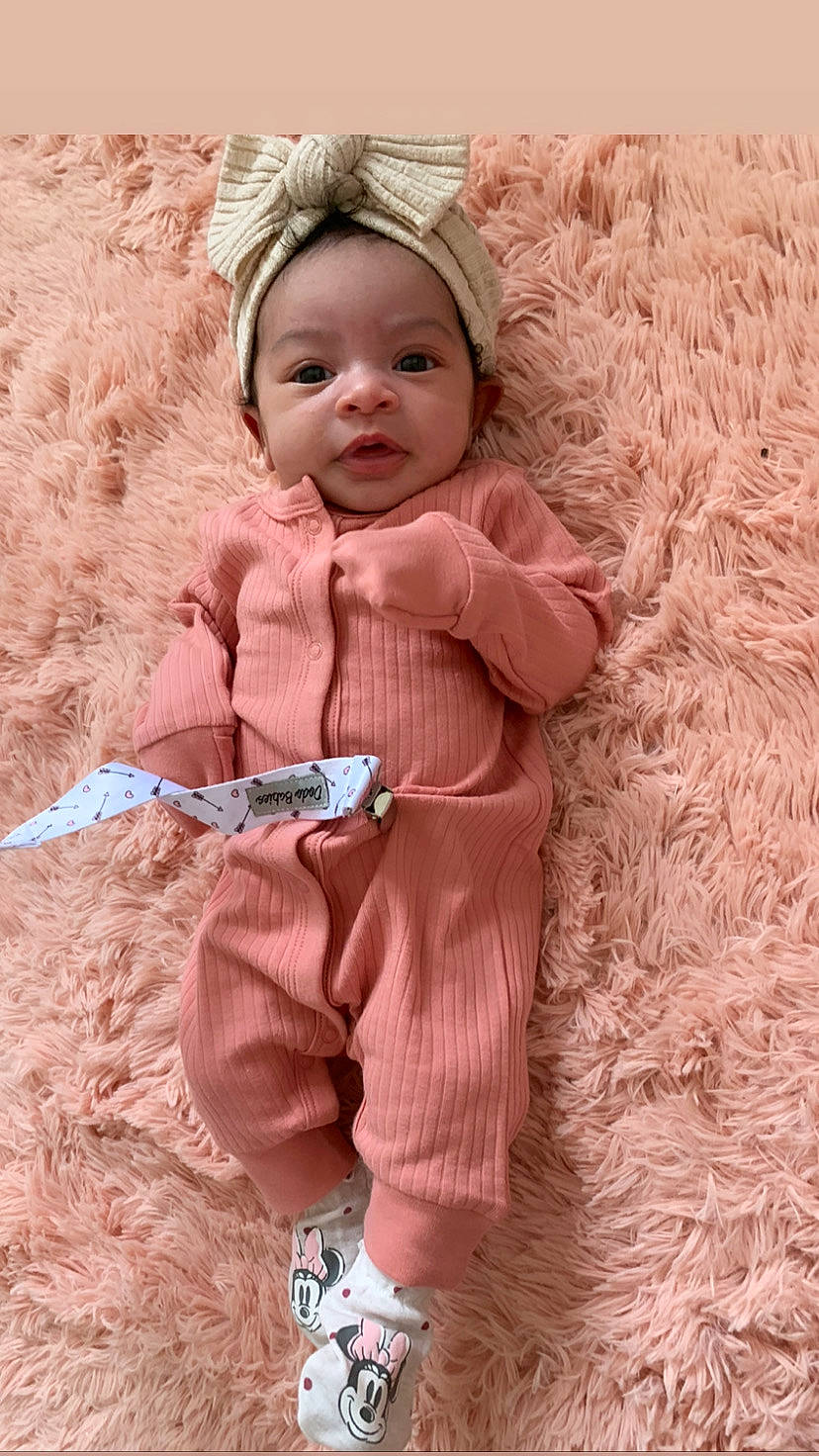 Denver joined the competition — help win amazing prizes! baby, baby_toddler_clothing, child, fashion_accessory, grass, hairstyle, happy, headgear, pattern, peach, people_in_nature, person, pink, sitting, skin, sleeve, smile, textile, toddler, vintage_clothing