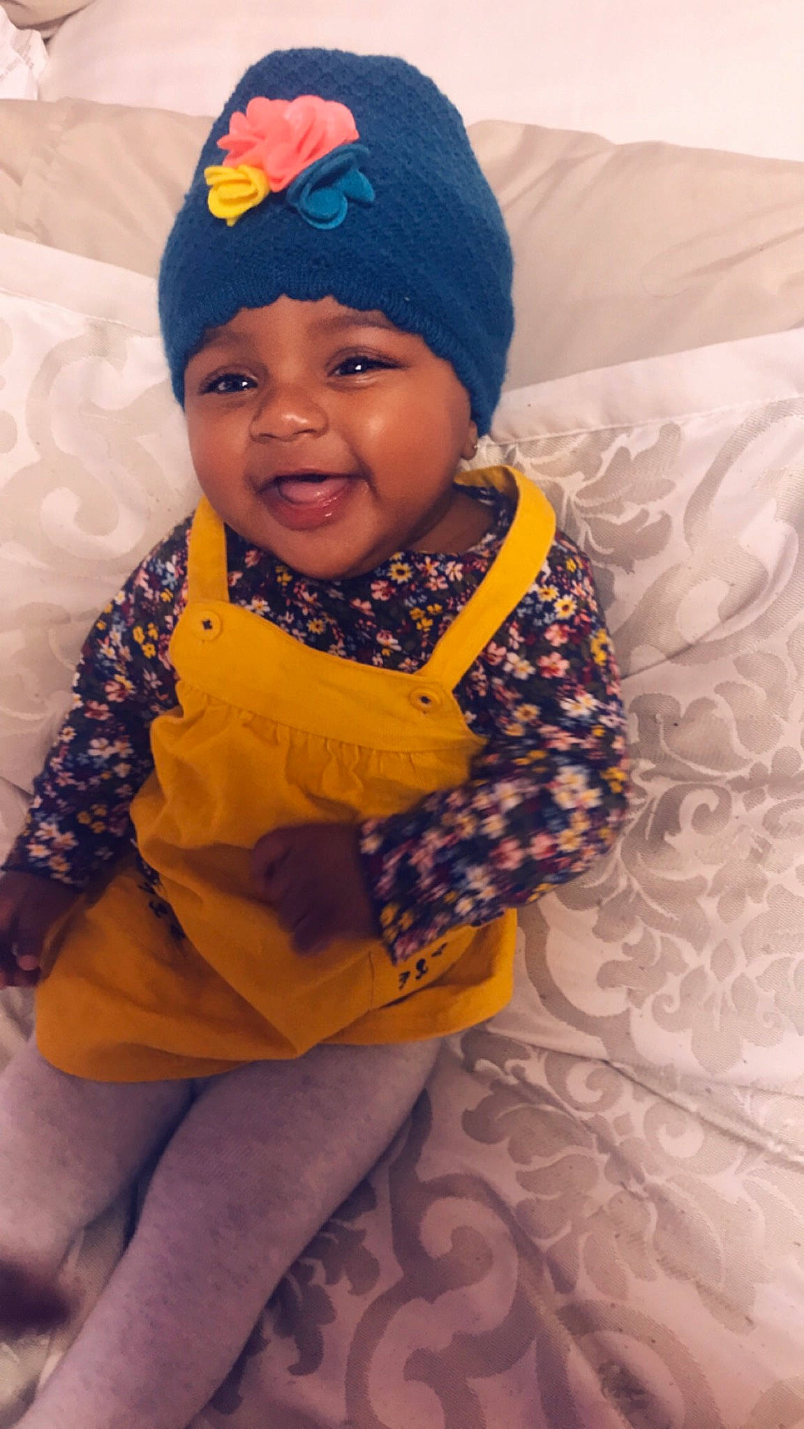 Amariana is registered to the contest to win money with this photo: baby, beanie, bonnet, cheek, child, face, facial_expression, fashion_accessory, hair_accessory, happy, head, headgear, headwear, knit_cap, person, play, skin, smile, toddler, yellow