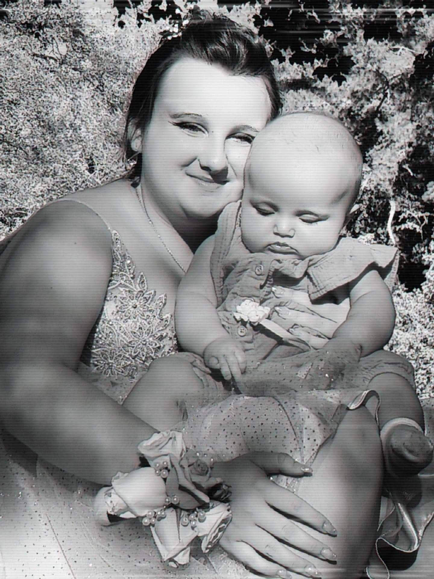 Isabella is registered to the contest to win money with this photo: baby, black, black_and_white, facial_expression, flash_photography, fun, gesture, grass, hairstyle, happy, joy, monochrome, monochrome_photography, people_in_nature, person, photograph, playing_with_kids, smile, style, toddler