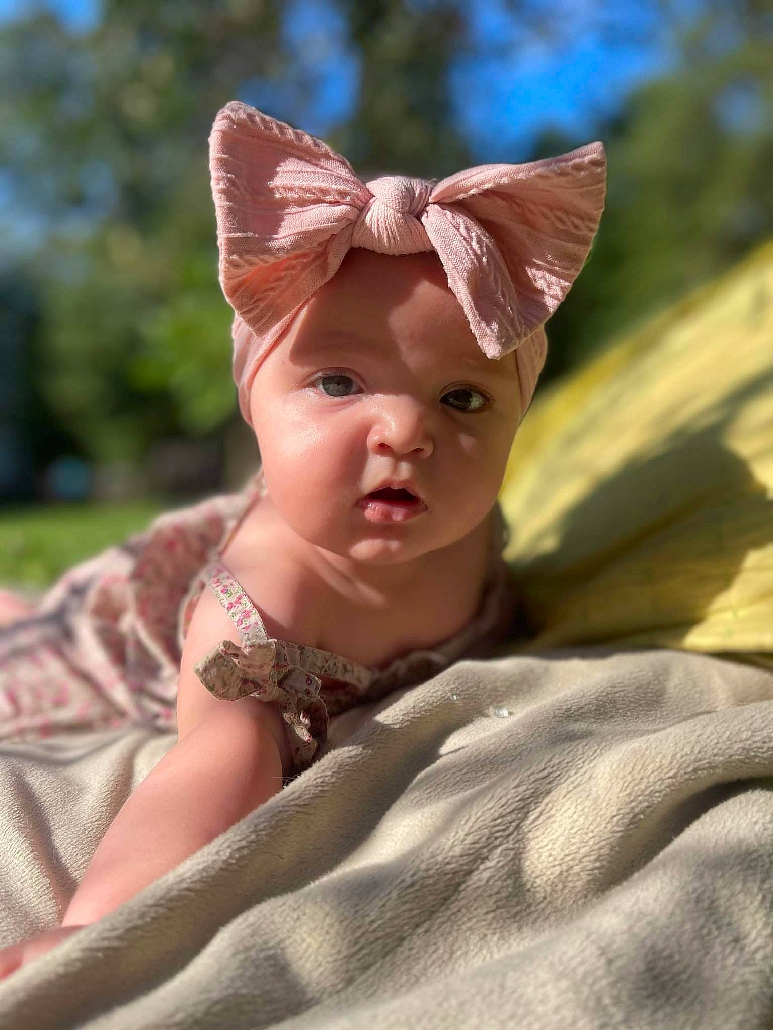 Shelby is registered to the contest to win money with this photo: baby, baby_toddler_clothing, child, fashion_accessory, fawn, finger, fun, grass, hair_accessory, happy, hat, head, headwear, human_body, landscape, people_in_nature, person, sitting, skin, sun_hat