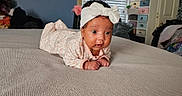 Camreigh is registered to the contest to win money with this photo: baby, bed, bedroom, bodypart, clothing, couch, crawling, cushion, face, finger, furniture, hat, head, homedecor, indoors, person, photography, portrait, quilt, room