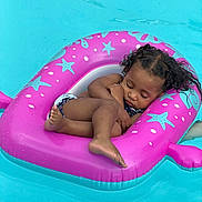 Camreigh is registered to the contest to win money with this photo: toddler, child, sleeping, pool, water, inflatable, float, pink, blue, curly_hair, summer, relaxation, vacation, outdoor, swimsuit, cute, resting, calm, baby, fun