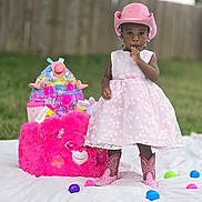J Zelle joined the competition — help win amazing prizes! toddler, child, pink_dress, cowboy_hat, cowboy_boots, plush_toy, pink_bear, outdoor, grass, wooden_fence, colorful_eggs, toy_basket, white_blanket, beads, ribbons, sucking_thumb, standing, cute, playful, portrait