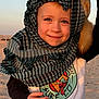 animal, child, cute, desert, face, fennec_fox, hand, happy, headwear, outdoor, person, playful, portrait, sand, scarf, smile, sunset_light, wildlife, yellow_pants, young_child