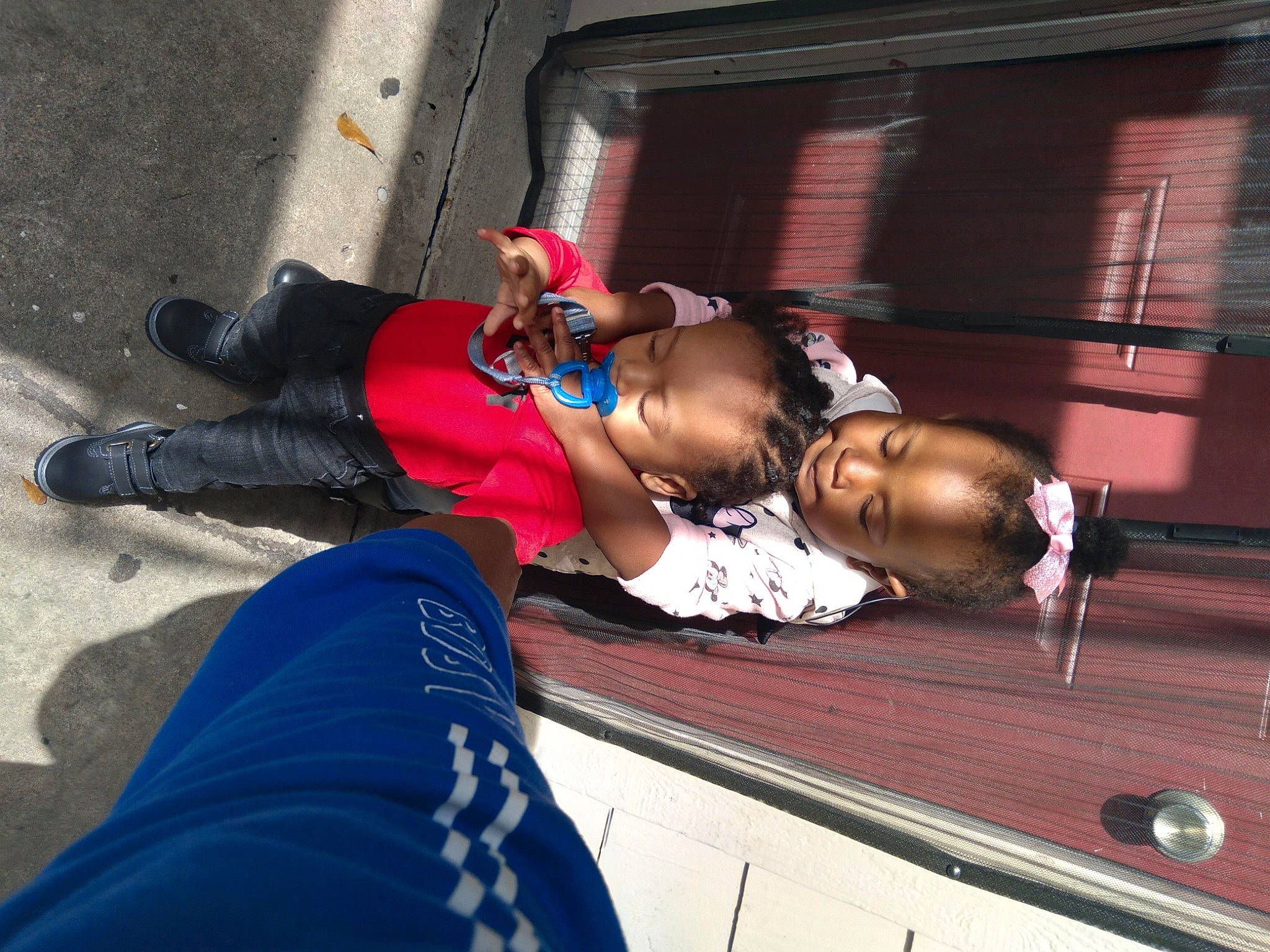 Noah is registered to the contest to win money with this photo: boot, child, clothing, electric_blue, entertainment, event, eyewear, fun, human_leg, leisure, performing_arts, person, personal_protective_equipment, recreation, sitting, sneakers, sunglasses, thigh, toddler, tree