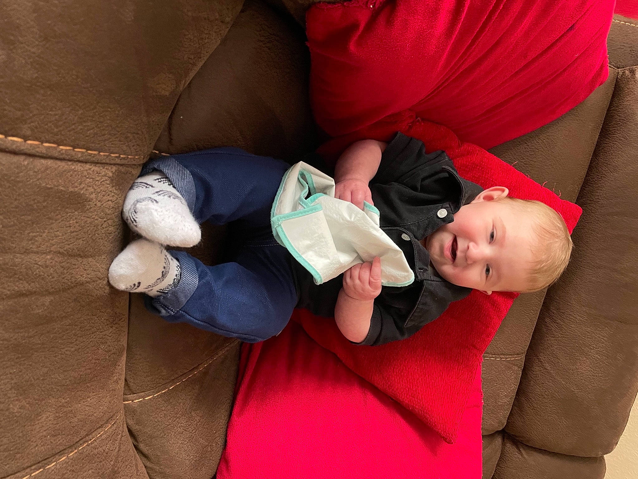 Poppy-rose is registered to the contest to win money with this photo: baby, baby_toddler_clothing, child, comfort, couch, elbow, finger, glasses, hand, human_body, human_leg, joint, knee, lap, leg, mouth, person, skin, textile, thigh
