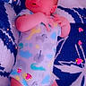 Caroline joined the competition — help win amazing prizes! baby, infant, onesie, dinosaur_pattern, blanket, blue, white, lying_down, digital_effects, hearts, sparkles, cute, child, sleeping, soft_lighting, indoors, newborn, small_hands, small_feet, cozy